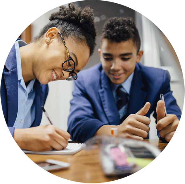 Male and female high school student working together on a classroom project